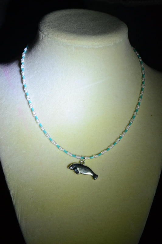 Manatee pendant glass bead necklace. Blue and white