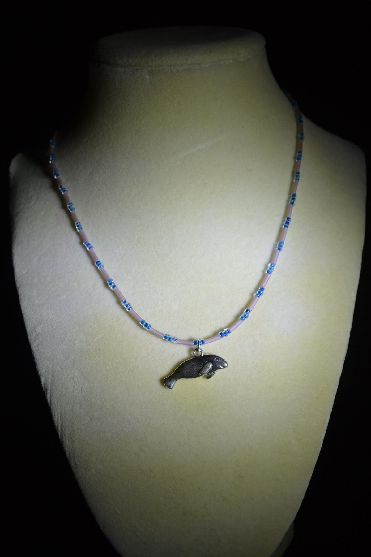 Silver Manatee pendant glass bead necklace. Navy and rose