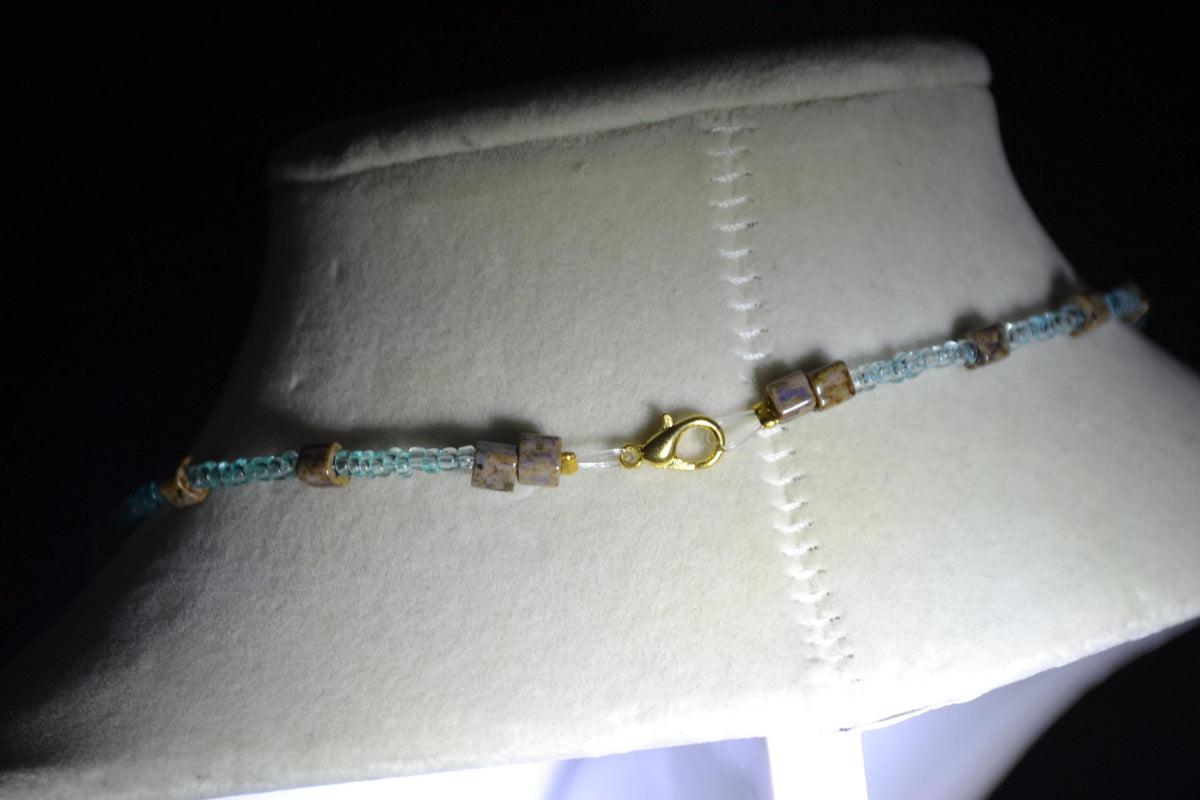 Feather pendant glass bead necklace. Teal and natural stone