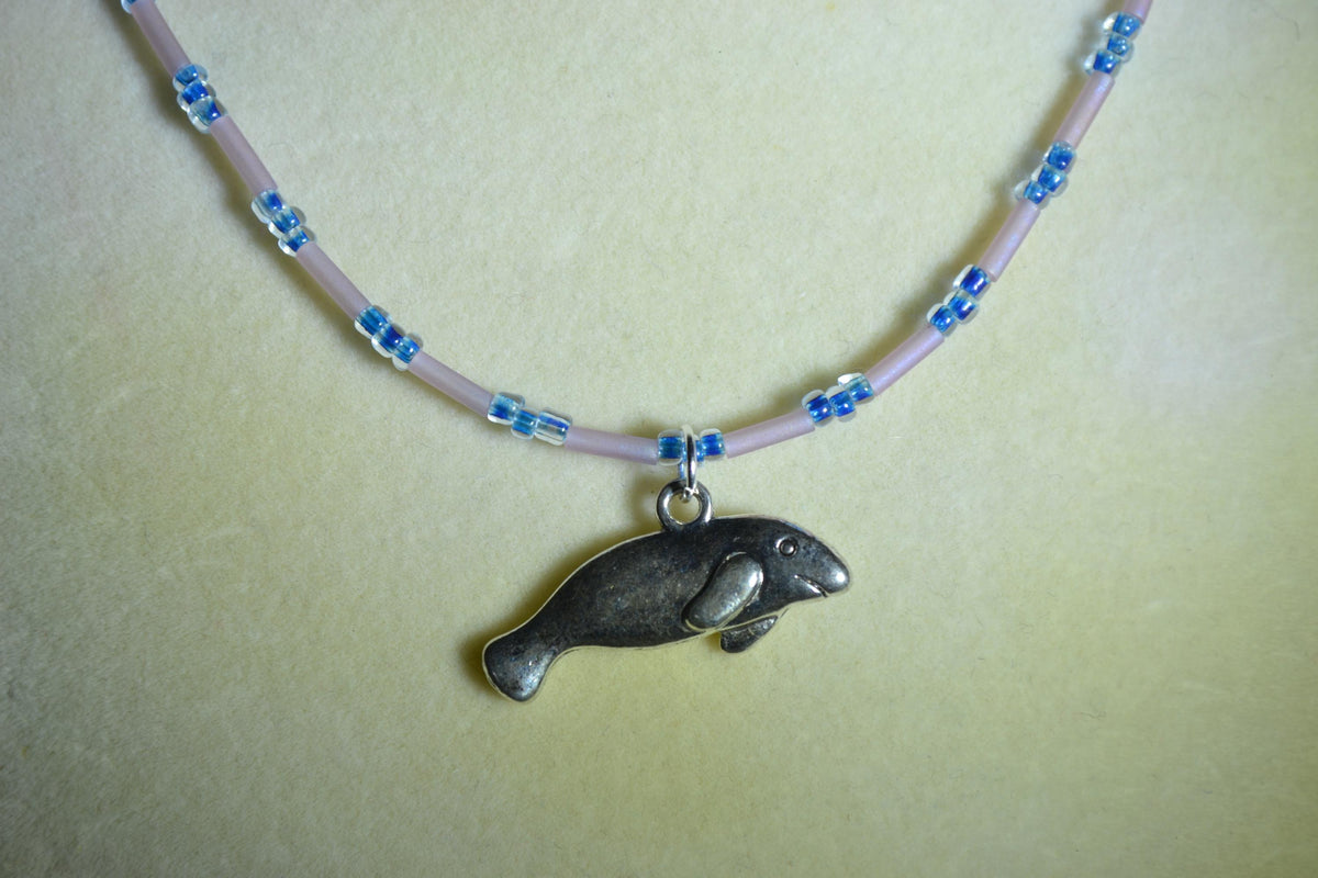 Silver Manatee pendant glass bead necklace. Navy and rose