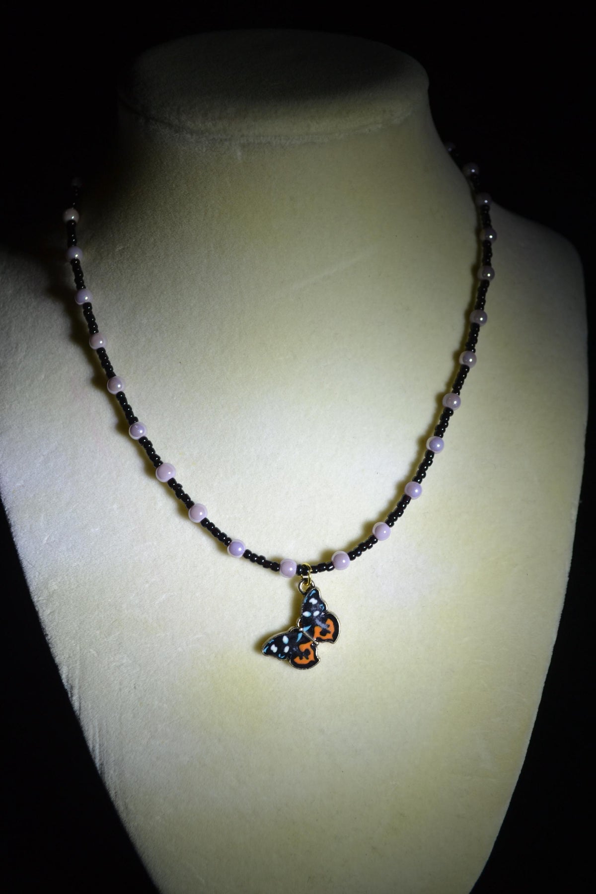 Butterfly pendant glass bead necklace. Purple and black