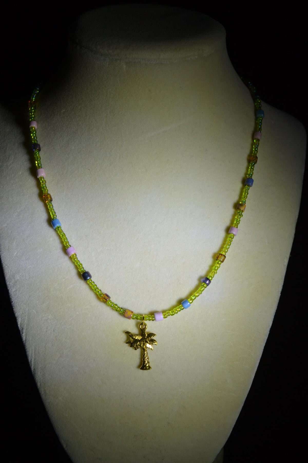 Gold Palm pendant glass bead necklace. Green and rainbow