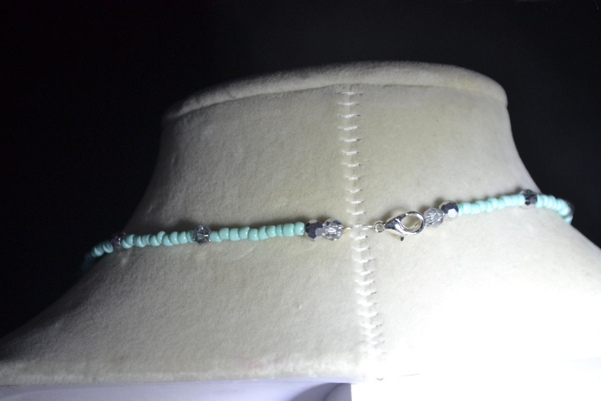 Silver Manatee pendant glass bead necklace. Aqua and silver
