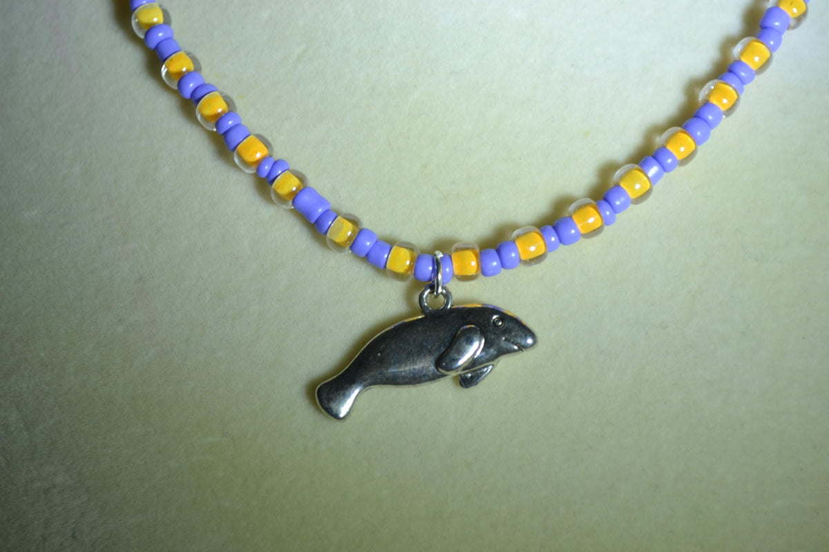 Manatee pendant glass bead necklace. Periwinkle and yellow