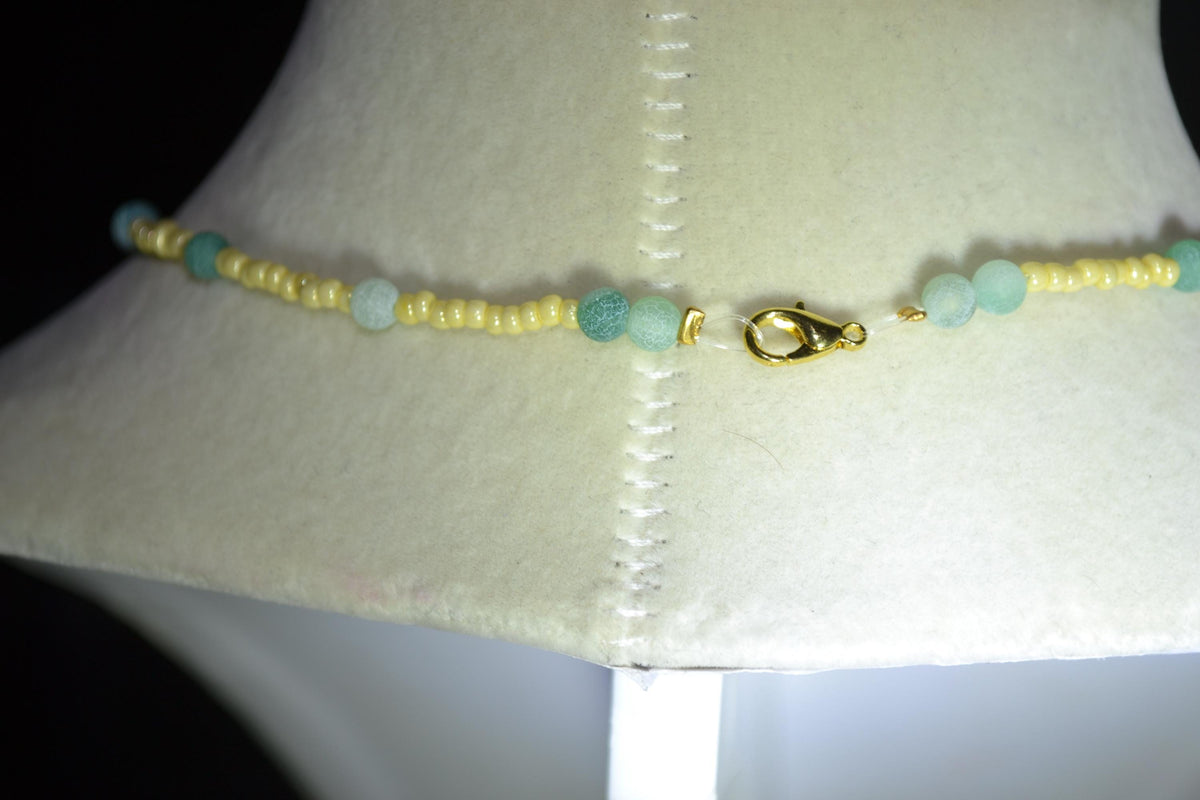 Gold scissor pendant glass bead necklace. Yellow and jade