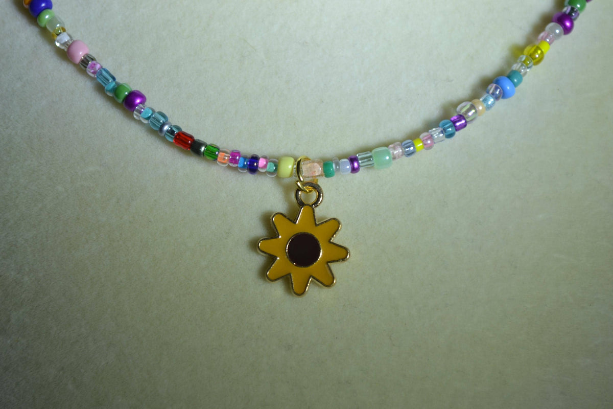 Sunflower pendant glass bead necklace. Rainbow