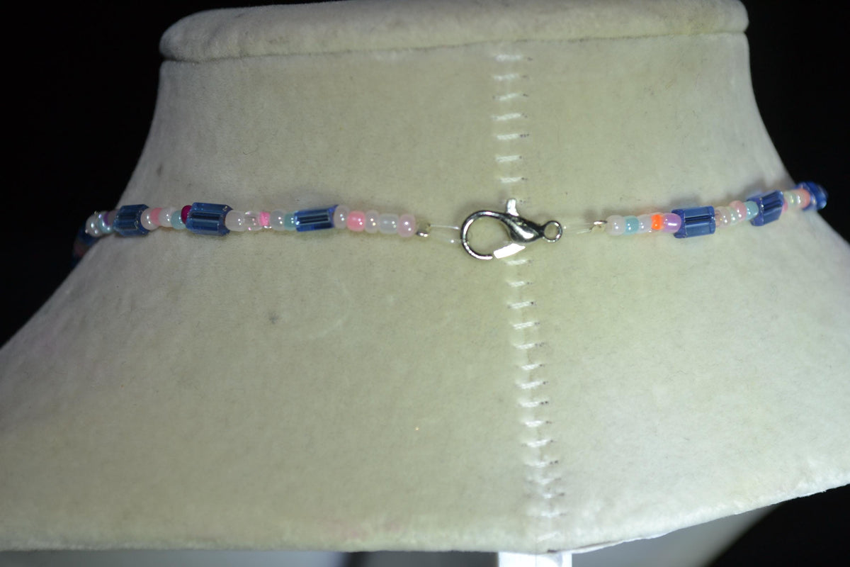 Silver Jaws head pendant glass bead necklace. Blue and pastels