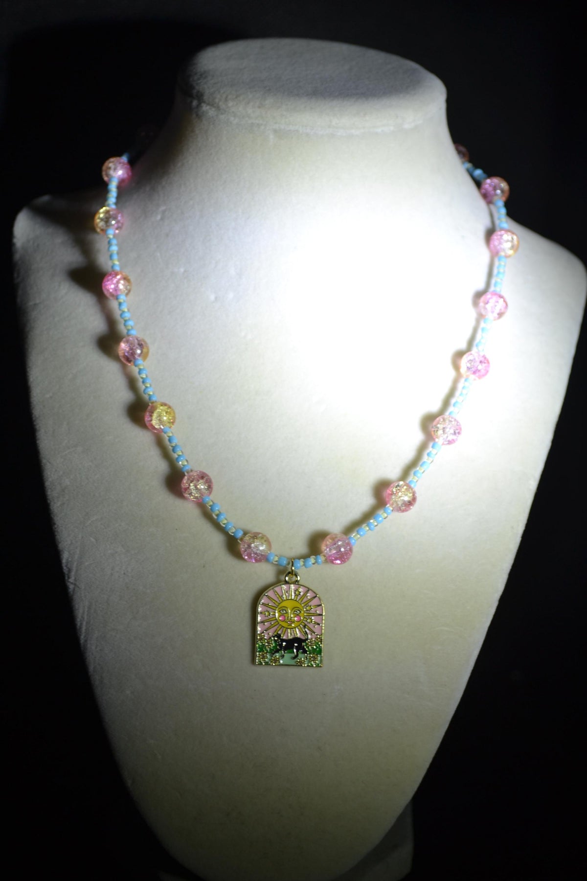 Black cat & sun pendant glass bead necklace. Blue, white, yellow, and pink