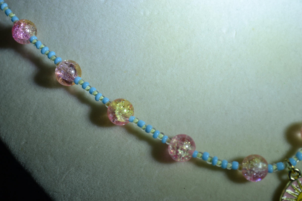 Black cat & sun pendant glass bead necklace. Blue, white, yellow, and pink