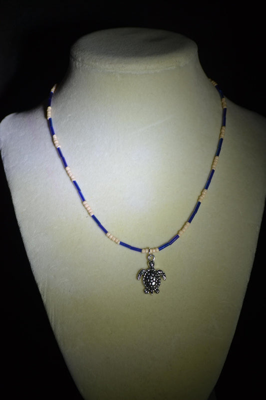 Silver turtle pendant glass bead necklace. Iridescent blue & sand