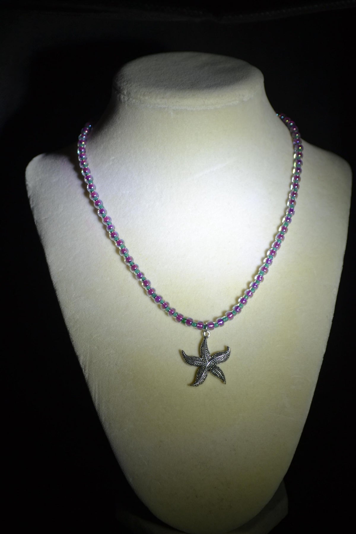 Silver starfish pendant glass bead necklace. Teal and iridescent pink