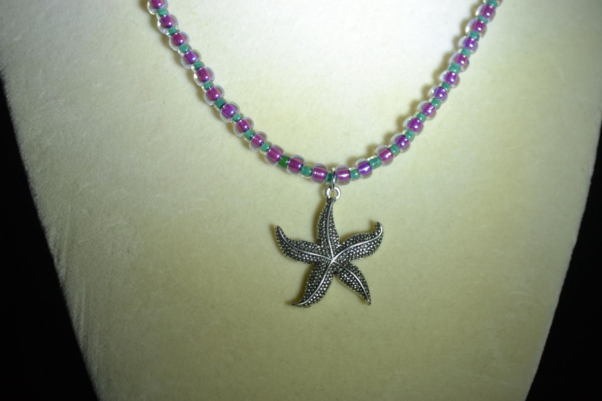 Silver starfish pendant glass bead necklace. Teal and iridescent pink