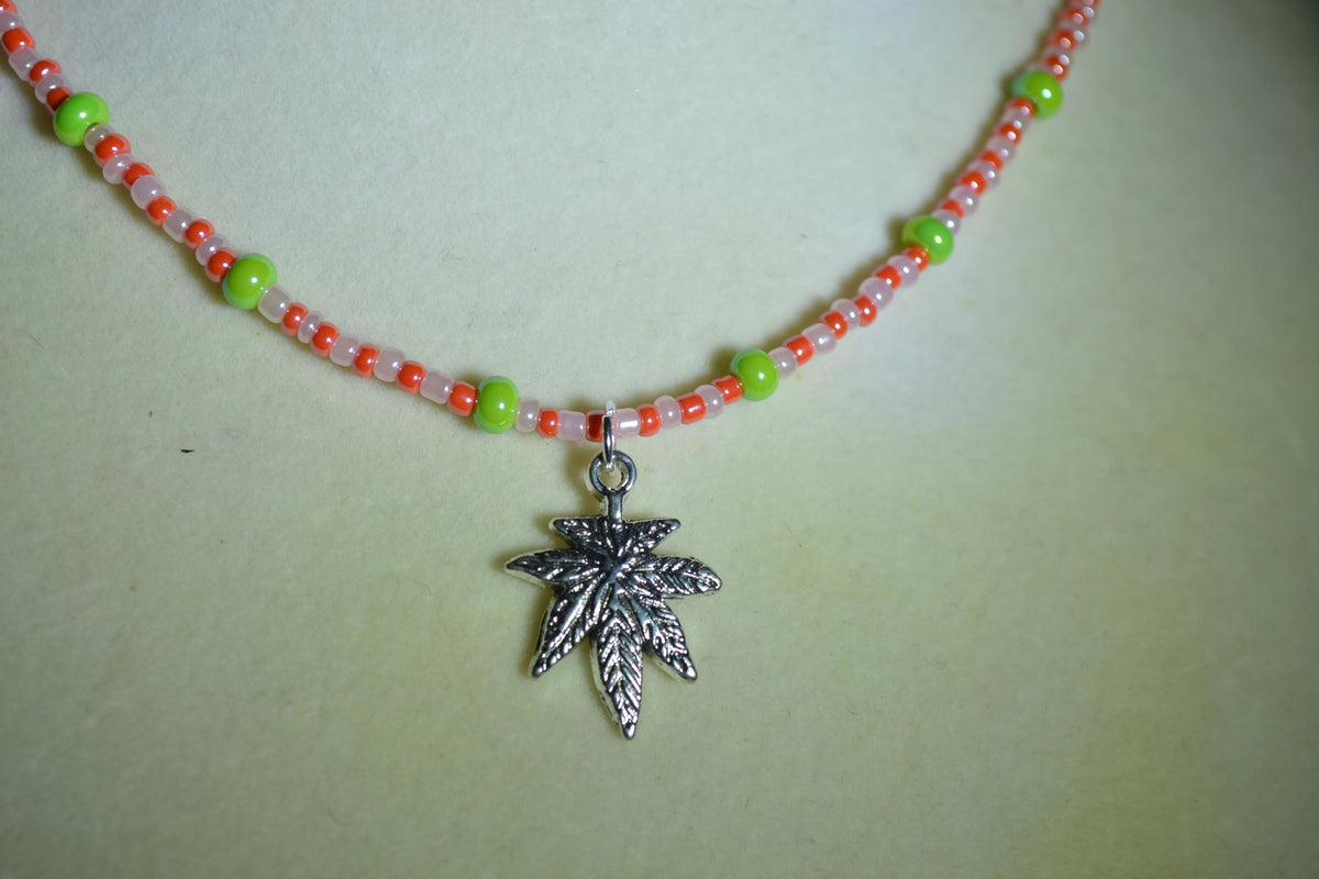 Silver marijuana pendant glass bead choker. Green, white, and orange