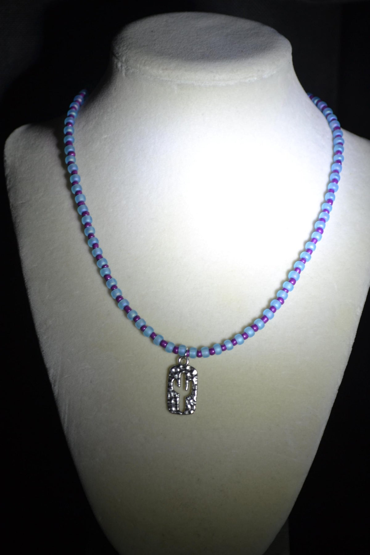 Silver Hammered cactus pendant glass bead necklace. Blue and purple
