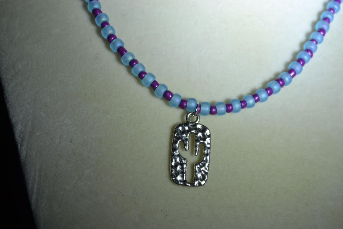 Silver Hammered cactus pendant glass bead necklace. Blue and purple