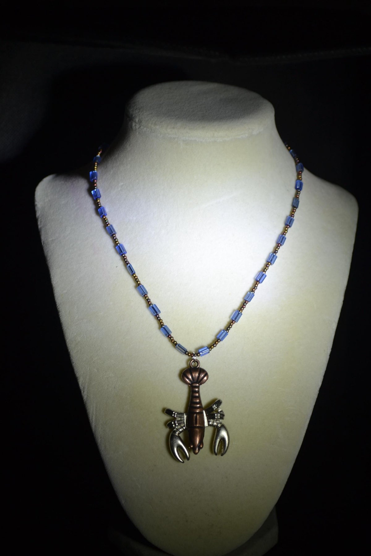 Bronze lobster pendant glass bead necklace. Mixed bronzes and blue