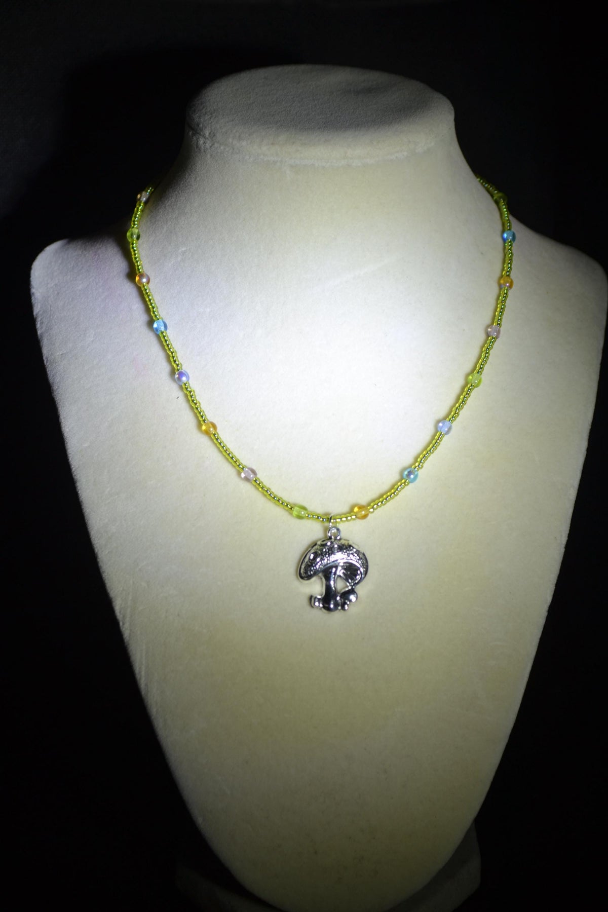 Silver mushroom pendant glass bead necklace. Green, blue, purple, and orange
