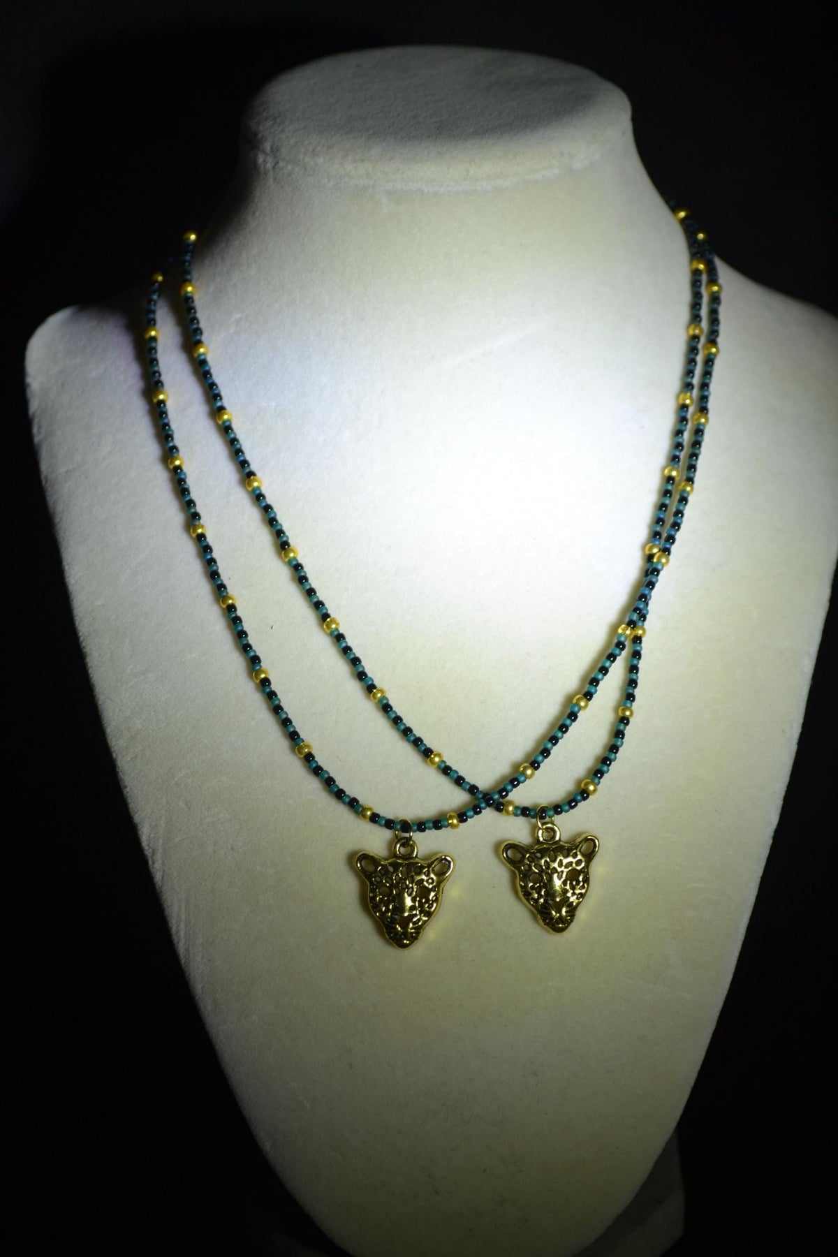 Gold Jaguar pendant glass bead necklaces. Teal, black, and gold