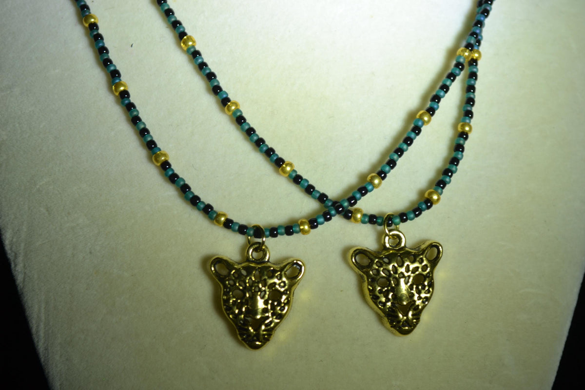 Gold Jaguar pendant glass bead necklaces. Teal, black, and gold