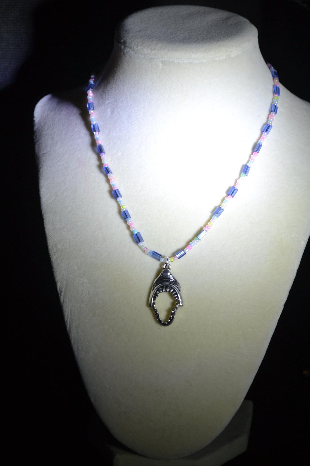 Silver Jaws head pendant glass bead necklace. Blue and pastels