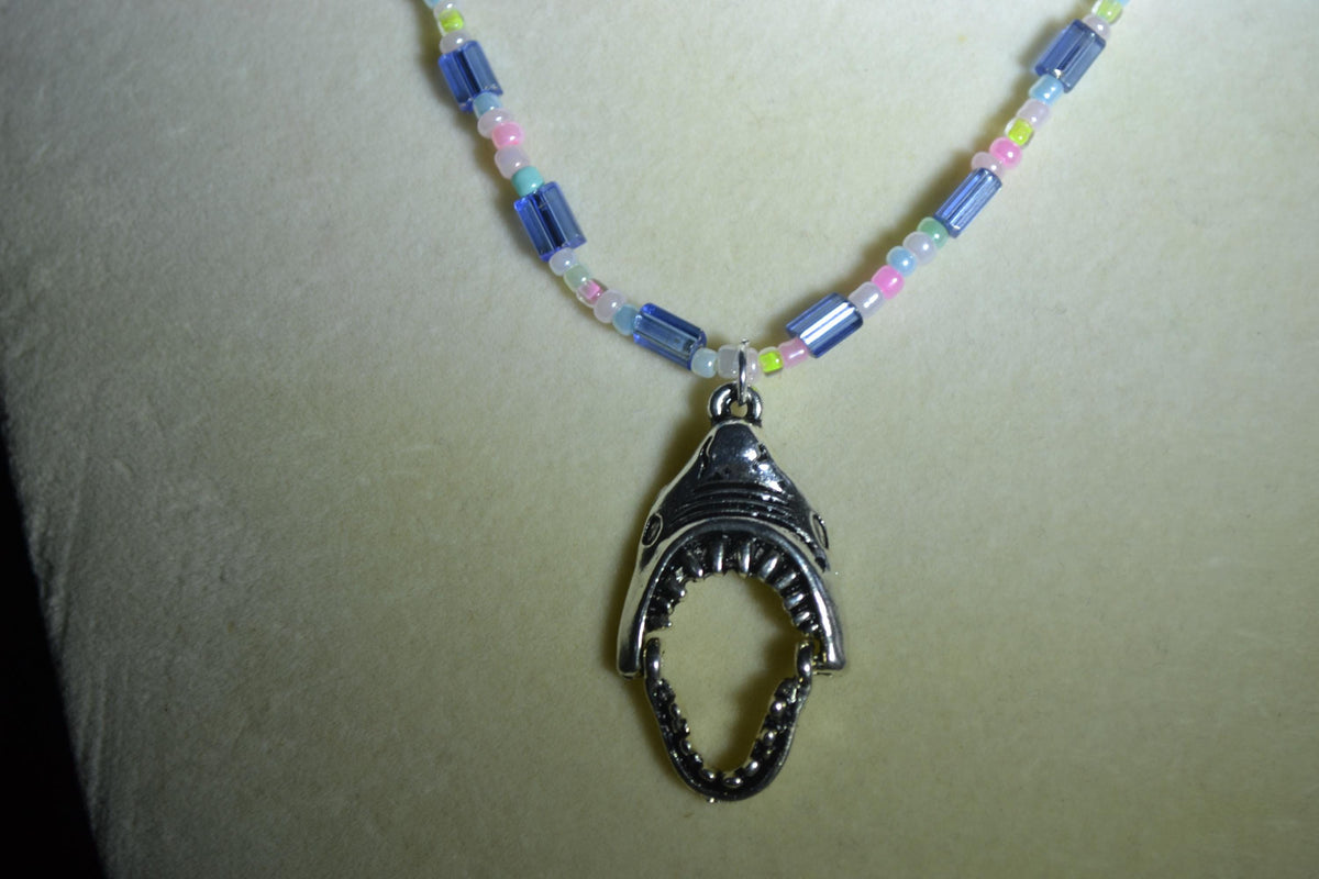Silver Jaws head pendant glass bead necklace. Blue and pastels