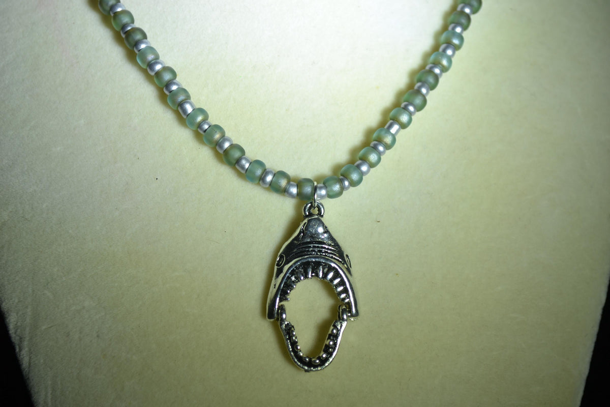 Silver Shark jaws pendant glass bead necklace. Frosted blue & silver