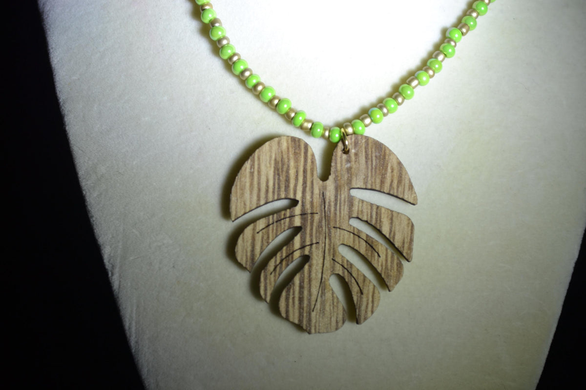 Wooden Monstera pendant glass bead necklace. Green and gold