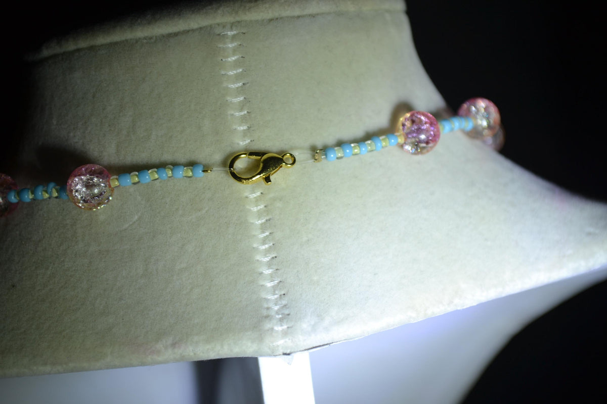 Black cat & sun pendant glass bead necklace. Blue, white, yellow, and pink