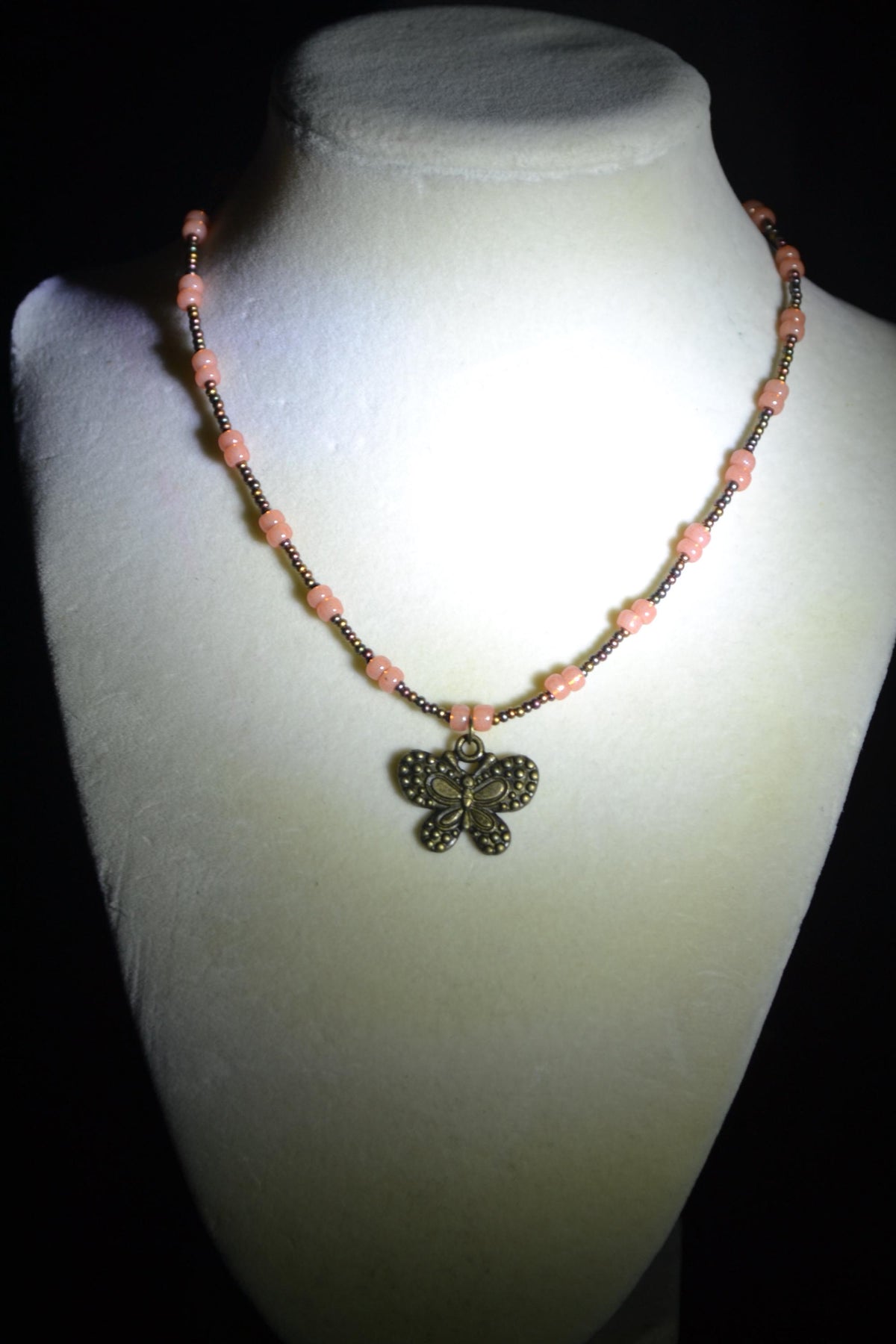 Bronze butterfly pendant glass bead necklace. Bronzes and coral