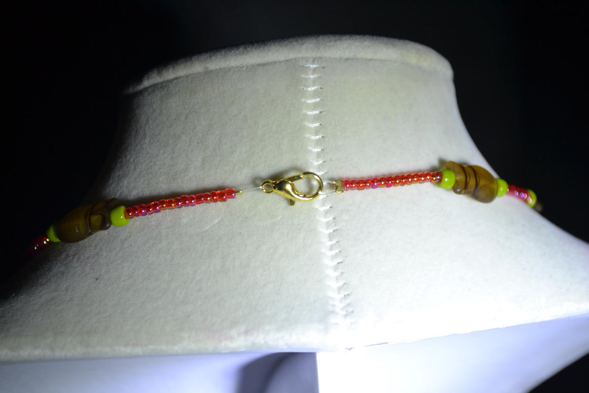 Beaded fish choker. Raspberry, olive, and topaz
