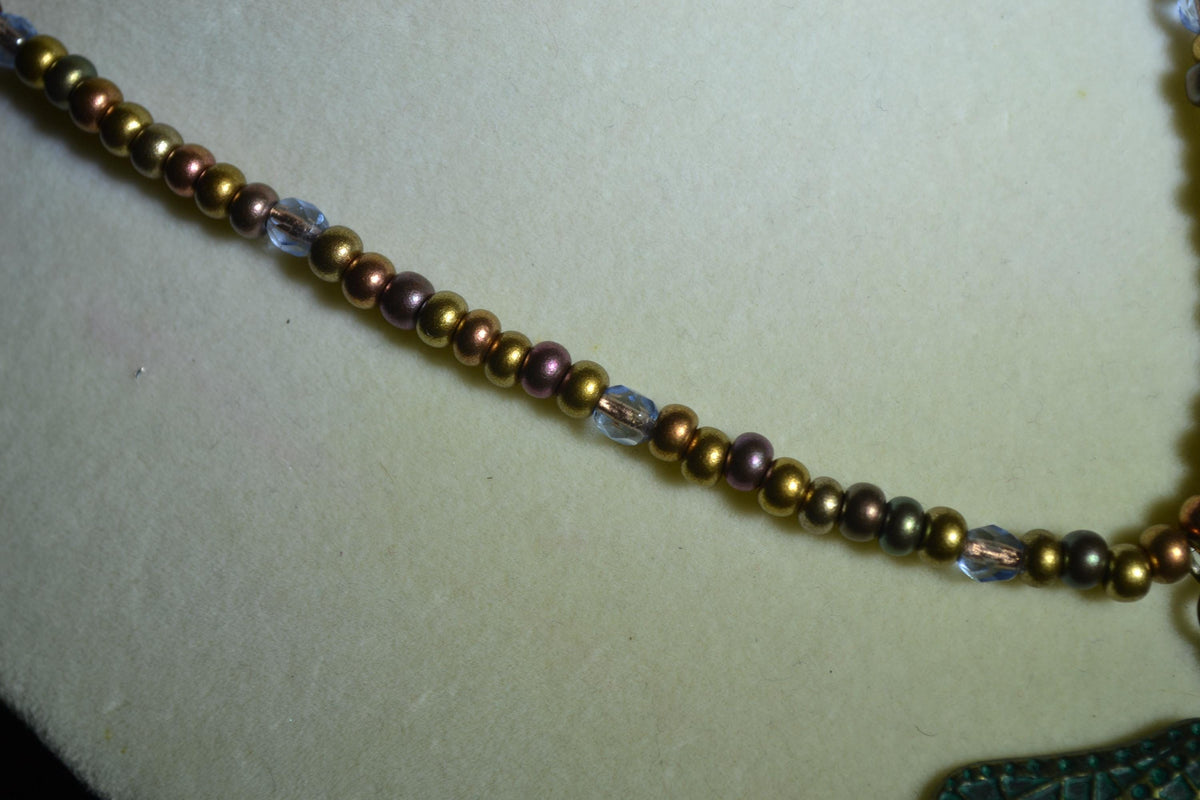Bronze Dragonfly pendant glass bead necklace. Mixed bronzes and light blue
