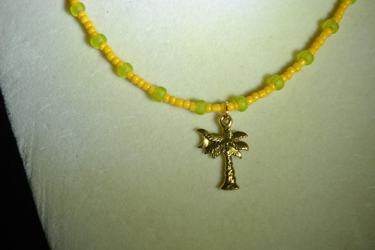 Gold palm pendant glass bead necklace. Tangerine & frosted green