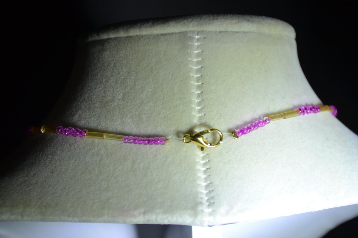 Gold fairy pendant glass bead necklace. Iridescent yellow & fuchsia