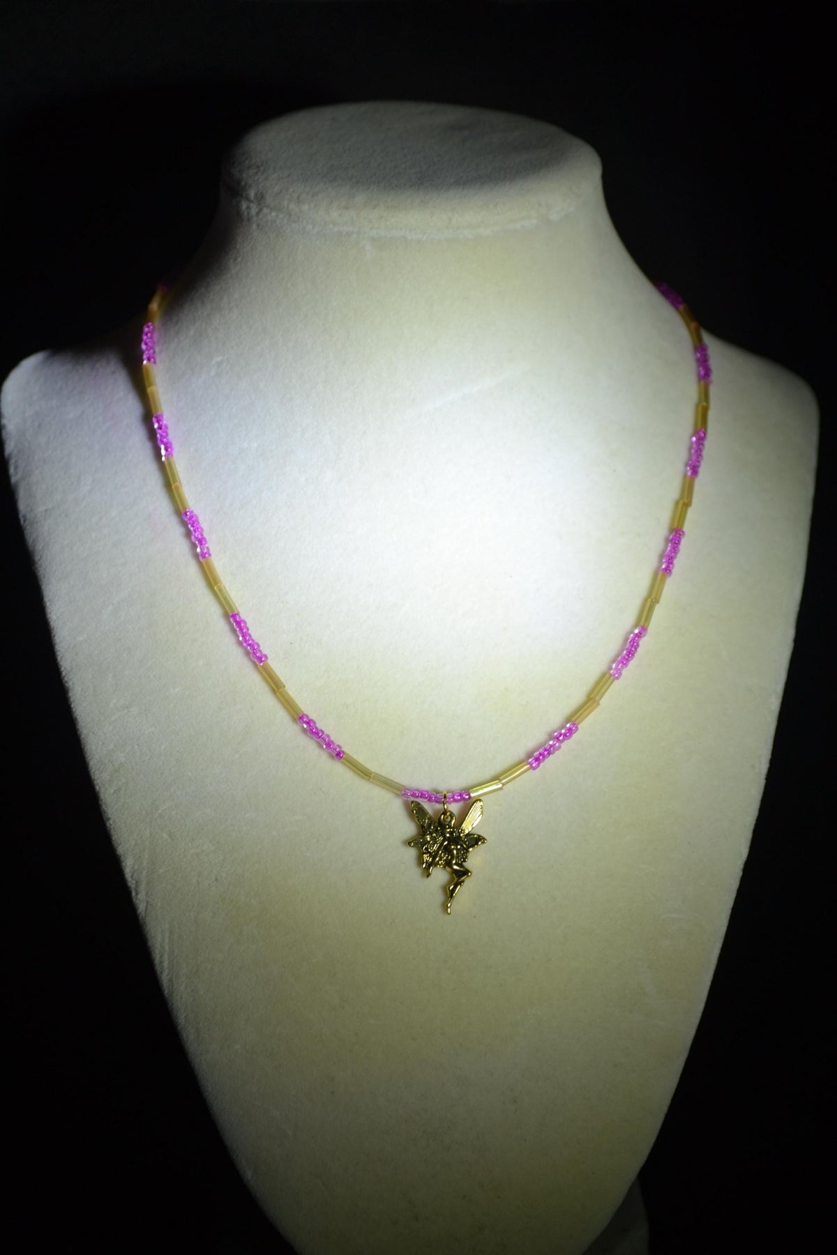 Gold fairy pendant glass bead necklace. Iridescent yellow & fuchsia