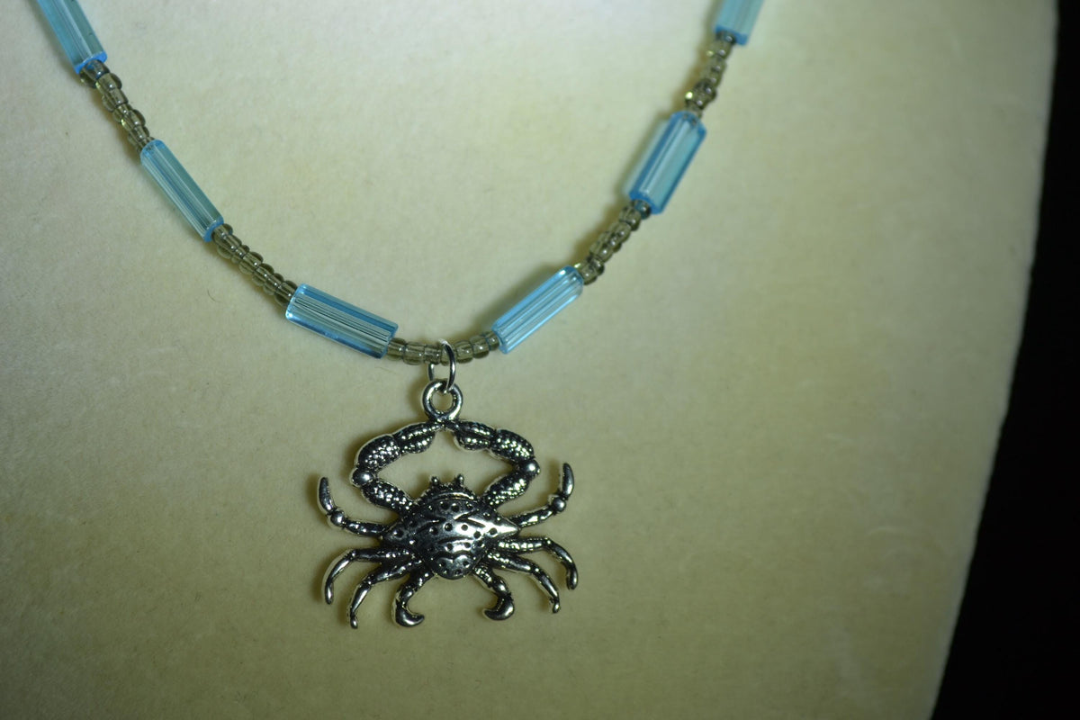 Silver crab pendant glass bead necklace. Blue and gray