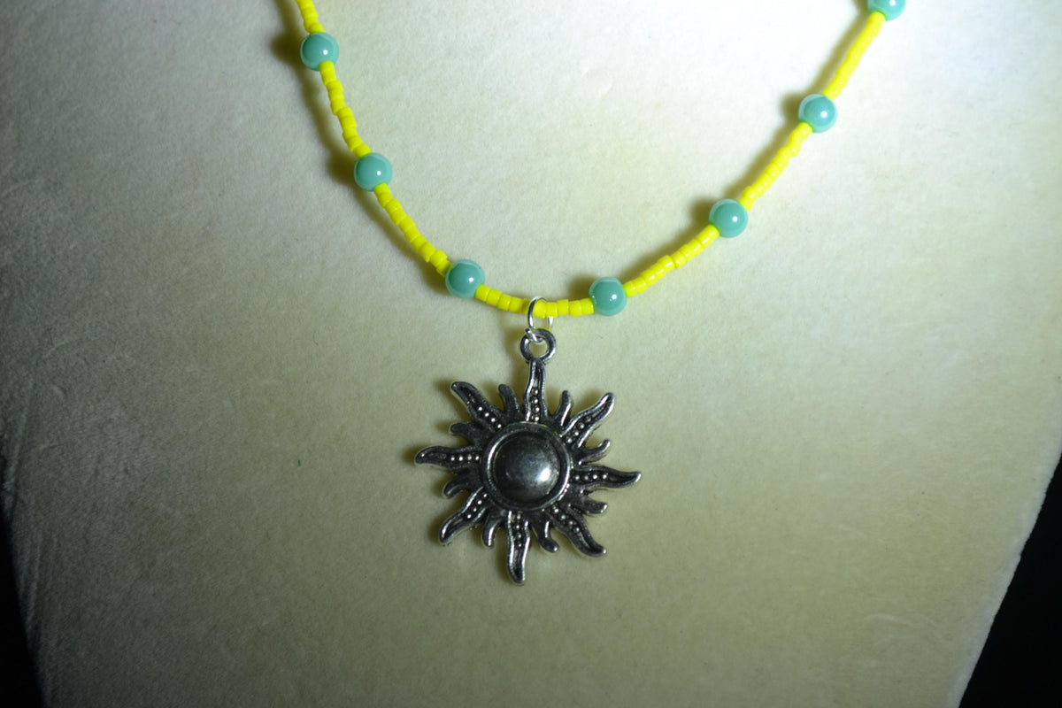 Silver sun pendant glass bead necklace. Yellow and turquoise
