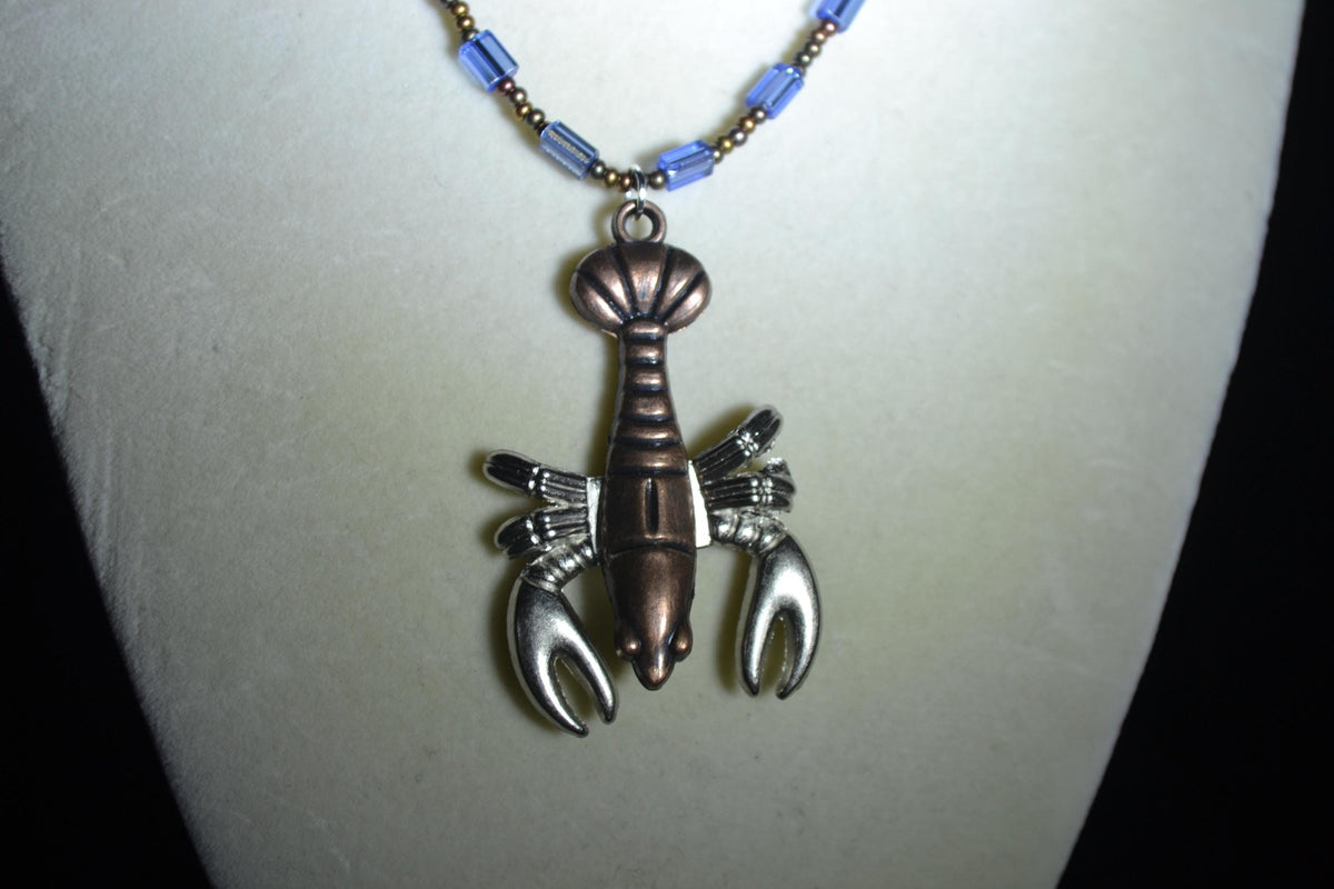 Bronze lobster pendant glass bead necklace. Mixed bronzes and blue