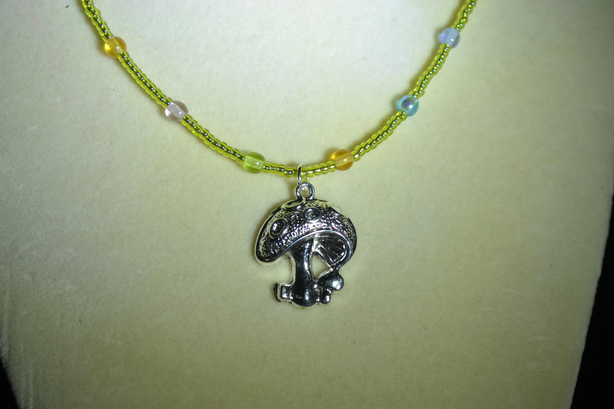 Silver mushroom pendant glass bead necklace. Green, blue, purple, and orange
