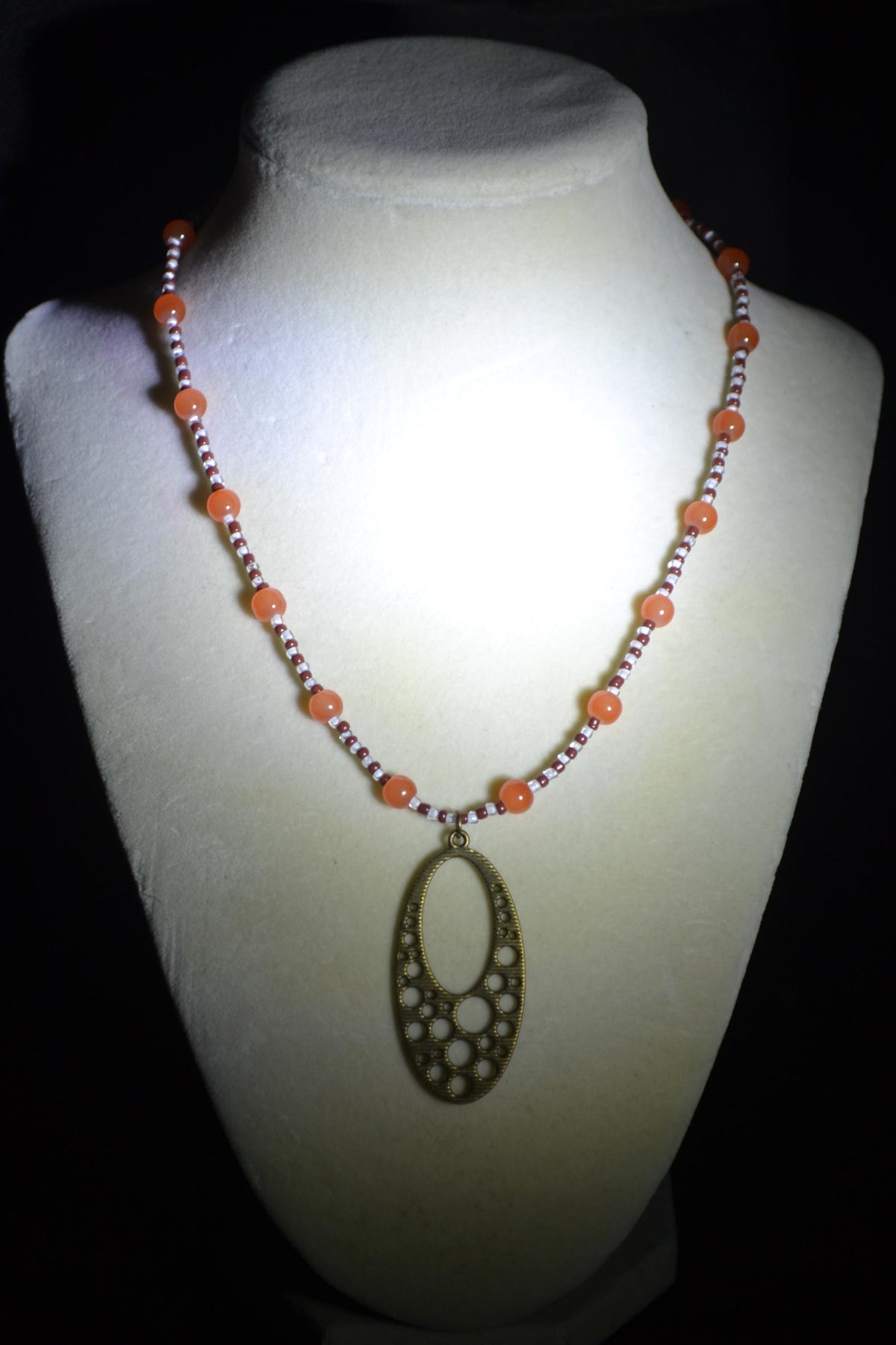 Brass bubbles pendant glass bead necklace. Orange, white, and brown