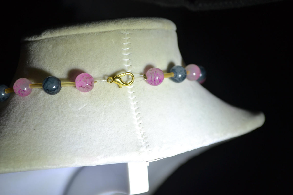 Gold Flower pendant glass bead necklace. Pink, black, and champagne