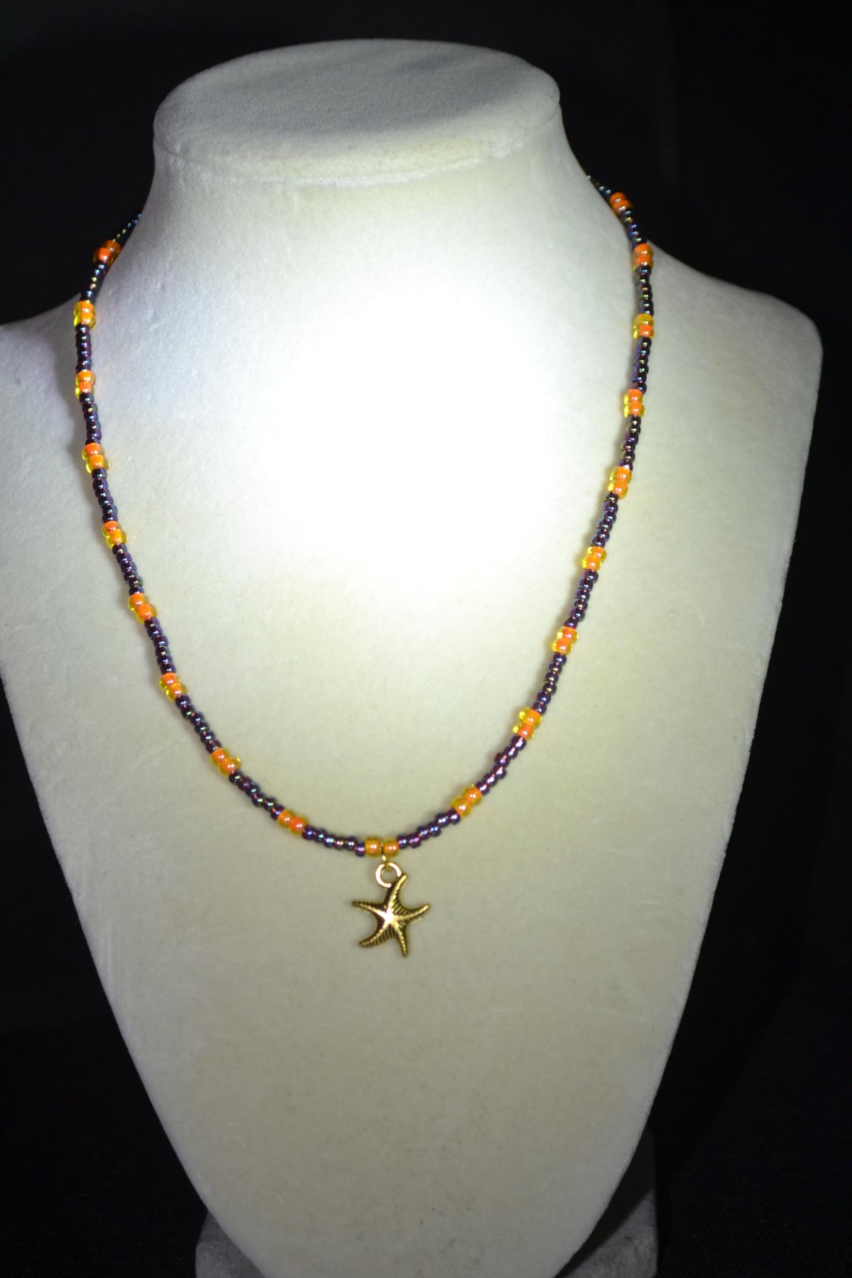 Gold Starfish pendant glass bead necklace. Amethyst and orange