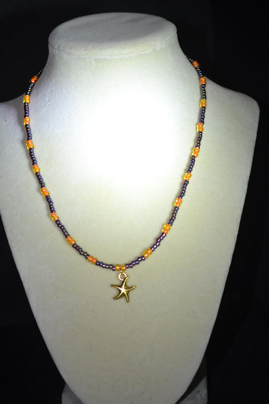 Gold Starfish pendant glass bead necklace. Amethyst and orange