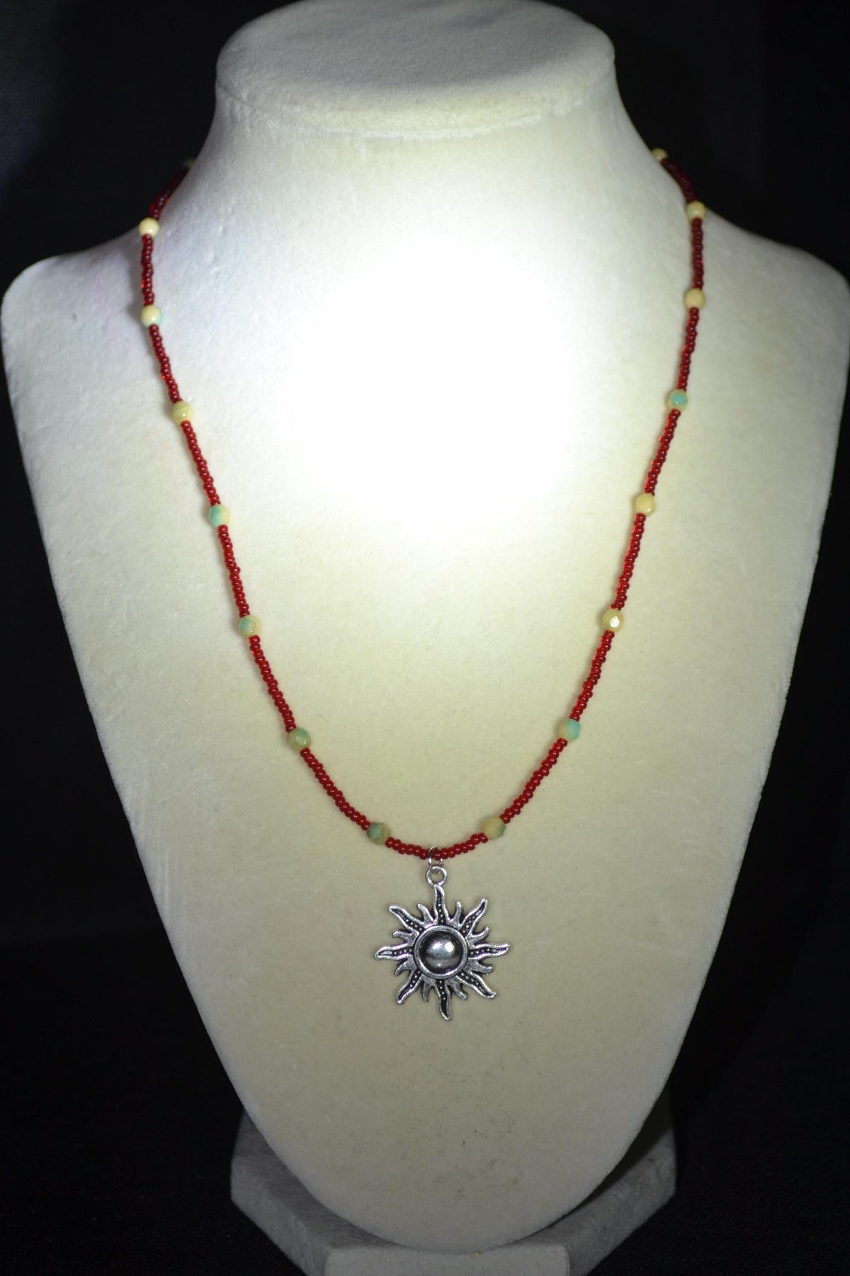 Silver Sun pendant glass bead necklace. Red, cream, and teal