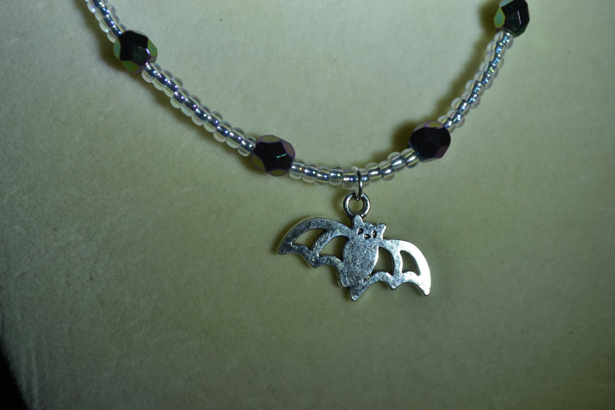 Silver Bat pendant glass bead necklace. Metallic black and crystal
