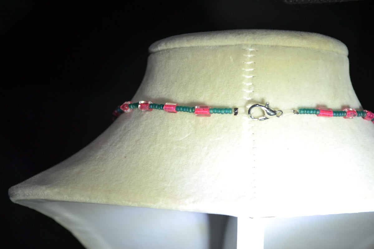Silver Parrot pendant glass bead necklace. Teal and fuchsia