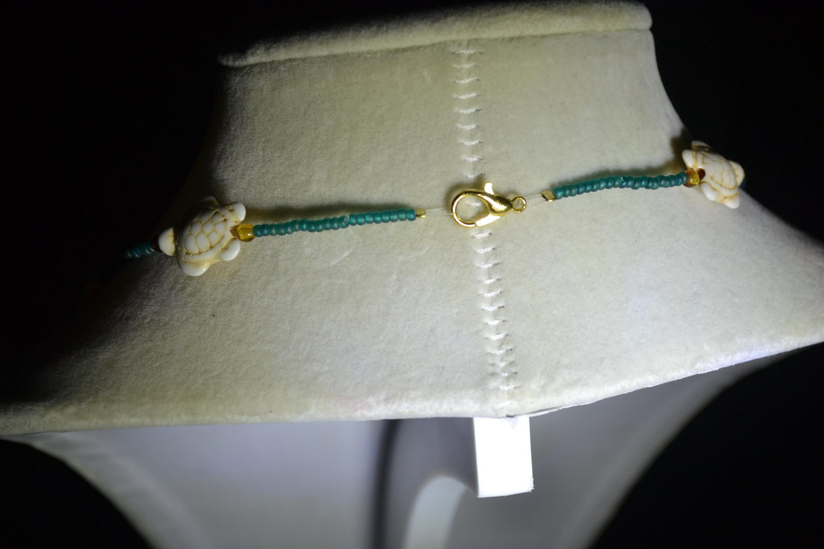 Multicolor glass bead necklace. White turtles, teal, and brown tortoise