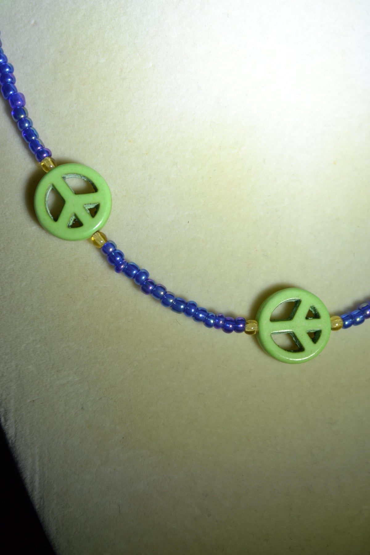 Multicolor glass bead necklace. Green peace sign, blue, and amber