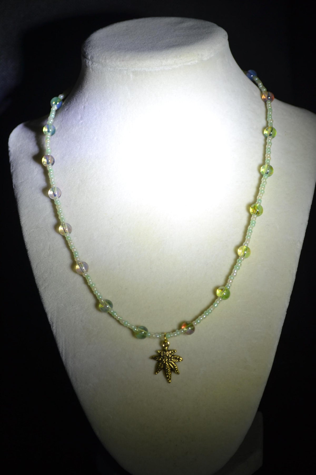 Gold Marijuana Leaf pendant glass bead choker. Pearl white, green, and topaz
