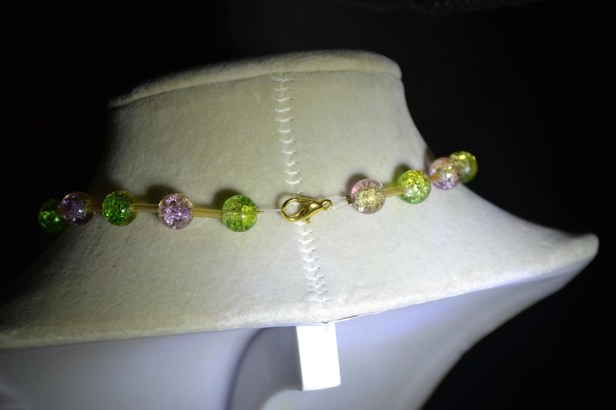 Gold Flower pendant glass bead necklace. Green, purple, and champagne