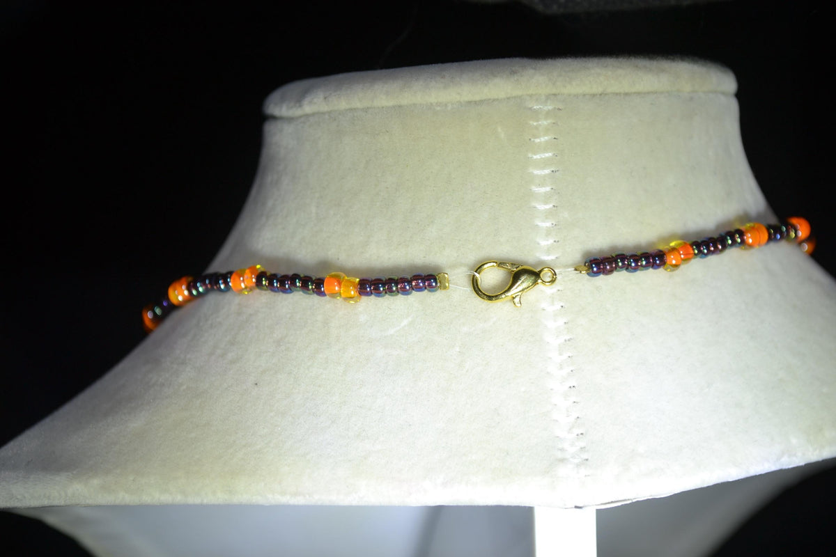 Gold Starfish pendant glass bead necklace. Amethyst and orange